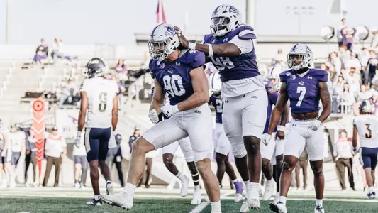 Kaghen Roach (90) celebrates a sack with Jerry Lawson (95)