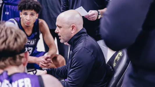 Brette Tanner talks to his team during a timeout at Baylor
