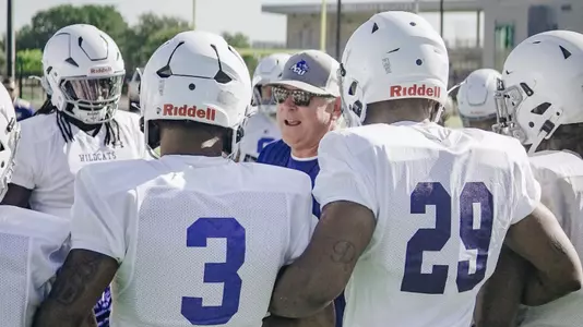 Keith Patterson talks to defensive players during practice on July 30, 2025