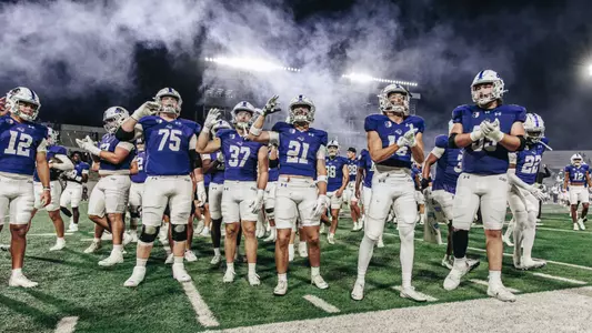 ACU football players celebrate during the fight song after beating Stephen F. Austin 28-20 on Sept. 6, 2025