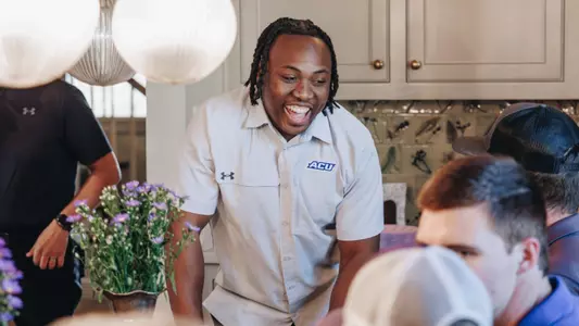 Anthony Egbo laughs with ACU football fans during an event on April 16, 2025