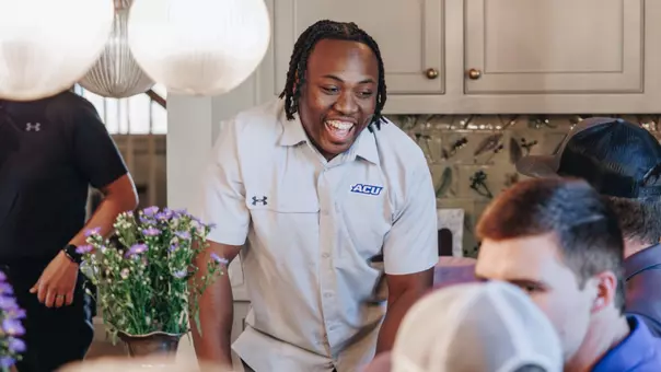Anthony Egbo laughs with ACU football fans during an event on April 16, 2025