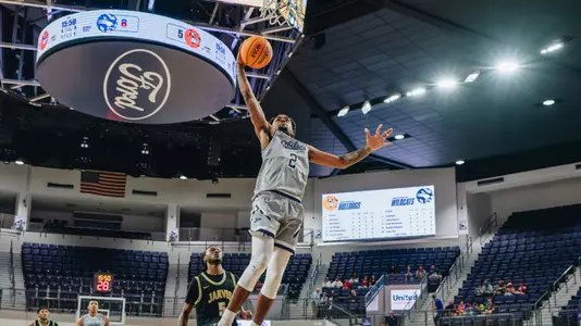 Yaniel Rivera jumps for a dunk against Jarvis Christian on November 28, 2025