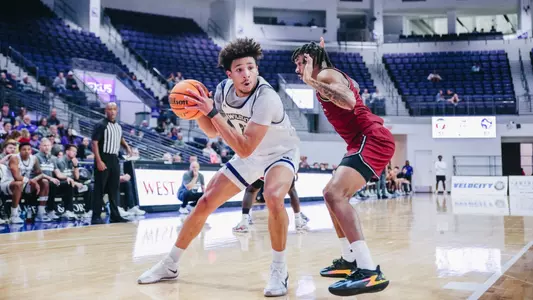 Joseph Venzant backs down a defender in the 2025-26 season