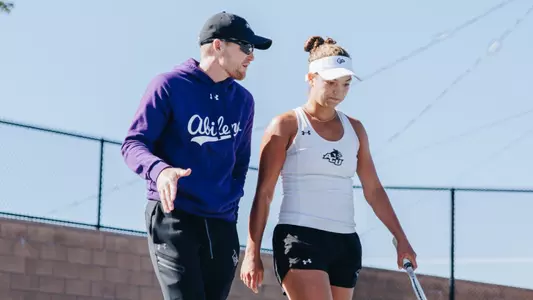 Women's tennis coach Bryan Rainwater talks with Masha Vrsalovic during the 2025 WAC Fall Invitational