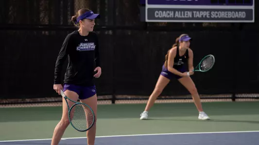 Victoria Correa and Angela Del Campo prepare to return a serve in their doubles match.