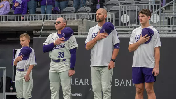 ACU baseball coaches Blaze Lambert and Rick McCarty stand for the national anthem before an opening series game vs. St. Thomas in Feb. 2026