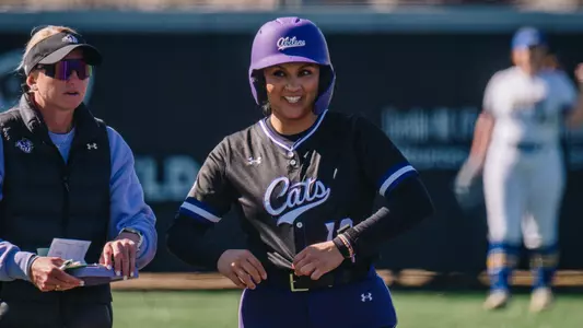 Valerie Ornelas smiles after reaching third base against South Dakota State