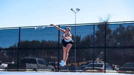 Masha Vrsalovic jumps in the air to return a ball in her match against Texas State on Feb. 15.