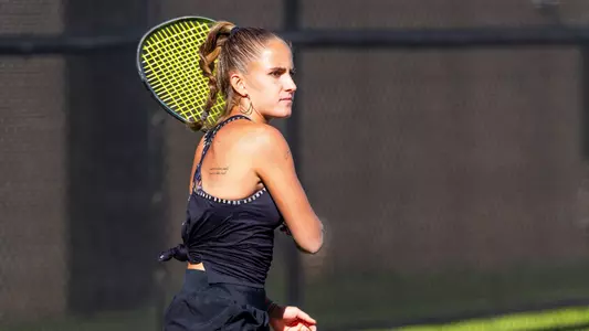 Maria Cascos watches as her opponent returns the ball.