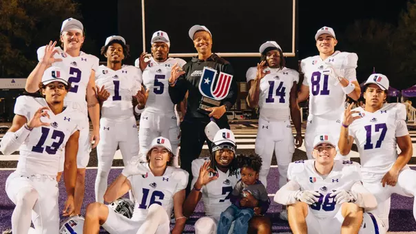 Receivers coach Joel Filani celebrates the 2025 UAC championship with players