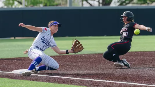 Emalee Romero slides to catch the softball and tag out a Texas Tech runner attempting to steal third base on March 31, 2026