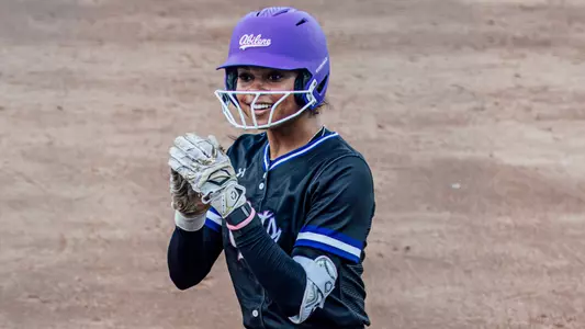 Ari Maxwell claps after reaching first base against Syracuse at the Bevo Classic in February 2026