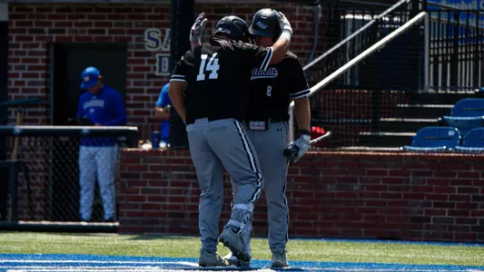 Grant Watkins congratulates Diego Cardenas on a home run in ACU's matchup with McNeese in Lake Charles, La. on March 29, 2026.