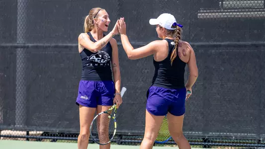 Alice Klinteby and Jess Board celebrate after winning a doubles point on April 1, 2026 against UT Arlington.