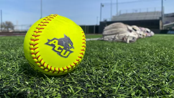 ACU softball with gloves in background