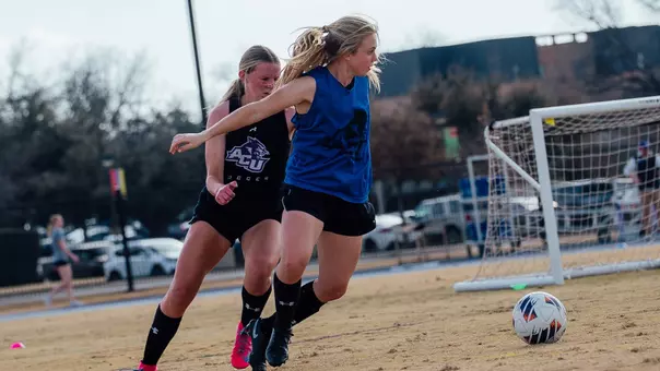 Chaney Maurer and Baylie Simon compete for a ball during an ACU soccer practice at Elmer Gray Stadium on Feb. 12, 2026.