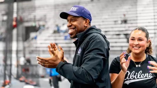 ACU track coach Miles Smith smiles and claps during the 2026 WAC Indoor Track and Field Championships.