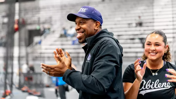 ACU track coach Miles Smith smiles and claps during the 2026 WAC Indoor Track and Field Championships.
