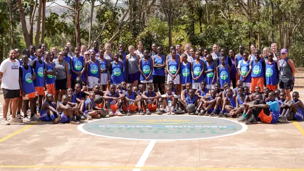 ACU women's basketball poses with students at Rwanda Children following its basketball clinic on Aug. 13, 2026.