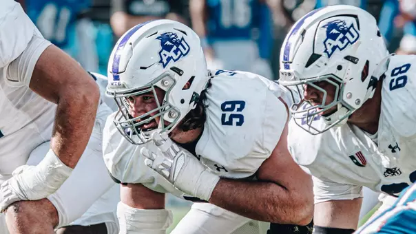 Landon Roaten (59) prepares for a snap at right guard, next to center Colter Lynch (68) during a game at West Georgia.