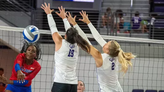 Maddie Finnegan and Avery Thaler attempt to block an attack in ACU's 3-0 win over Louisiana Tech at Moody Coliseum on Sept. 17, 2026.