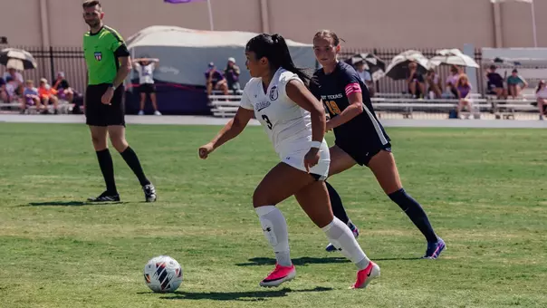 Mikayla Abrenica dribbles past a defender on Aug. 30, 2026, against East Texas A&M.