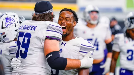 Landon Roaten hugs Dillon Williams, who yells in excitement, after ACU's 41-39 win at Idaho on Sept. 19, 2026