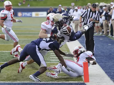 Football Drops High-Scoring Contest to Miami, 56-49 Image