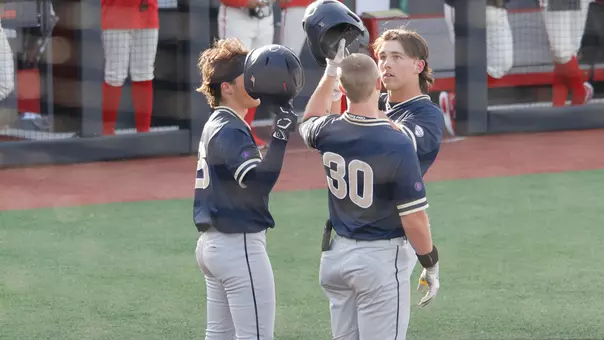 The Akron Baseball team celebrating a home run hit by Easton Amundson