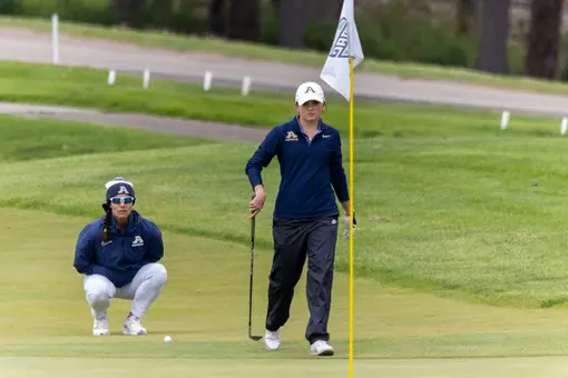 Kaitlin Kormuth approaces green, Coach King checking the line