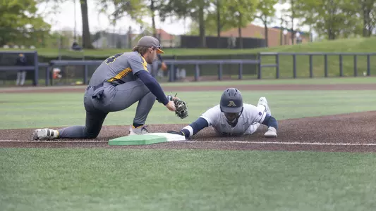 Action photo of Kelton Philliphs sliding back to 1st against Kent State
