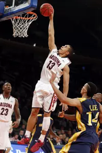 Arizona's Nick Johnson (13) goes to the