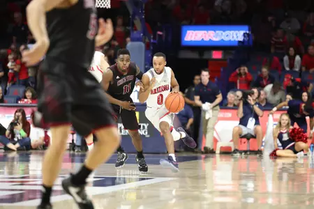 Parker Jackson-Cartwright drives up the court in exhibition play.