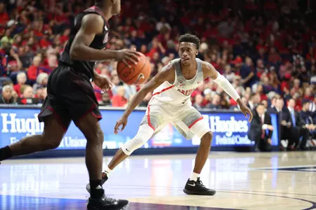 Kobi Simmons checks a Chico State player in the backcourt.