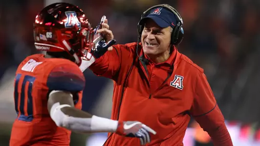 Rich Rodriguez high-fives Samajie Grant