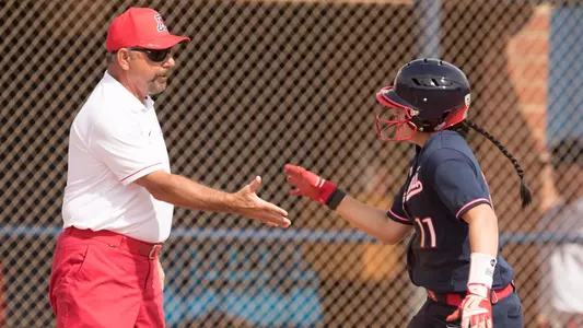 Head coach Mike Candrea and senior shortstop Mo Mercado (11)