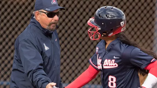 Head coach Mike Candrea and freshman catcher Dejah Mulipola (8)