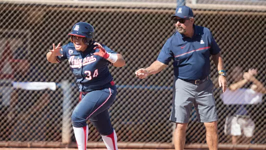Senior 3rd baseman Katiyana Mauga (34) and head coach Mike Candrea