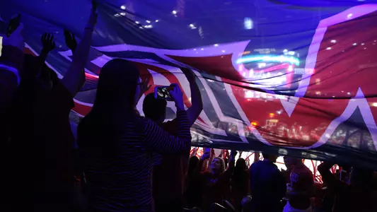 The Zona Zoo under the pregame flag at McKale Center