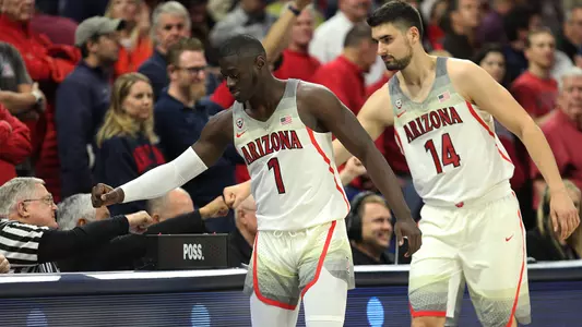 Rawle Alkins and Dusan Ristic dab up the McKale Center table crew prior to the ASU game.