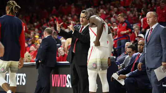 Coach Sean Miller and Rawle Alkins talk during a timeout.