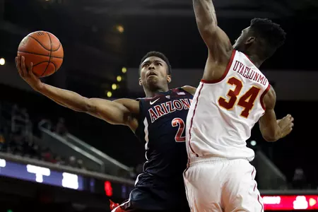 Arizona's Brandon Williams shoots next to Southern California's Victor Uyaelunmo during the second half of an NCAA college basketball game Thursday, Jan. 24, 2019, in Los Angeles. USC won 80-57. (AP Photo/Jae C. Hong)