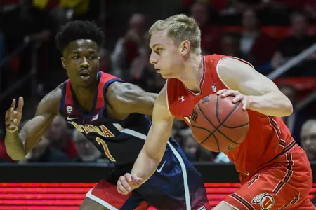 Arizona guard Devonaire Doutrive (1) defends Utah guard Parker Van Dyke, right, during the first half of an NCAA college basketball game Thursday, Feb. 14, 2019, in Salt Lake City. (AP Photo/Alex Goodlett)