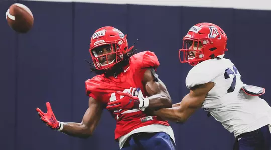 Arizona Wildcats wide receiver Thomas Reid III (16) focuses on a pass as cornerback Malik Hausman (23) closes in during the ninth day of Arizona Wildcats football practice 8/5/2019 at Arizona Stadium in Tucson, Ariz.Mike Christy / Arizona Athletics