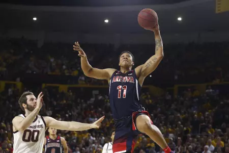 Arizona forward Ira Lee (11) goes in for a dunk as he gets past Arizona State forward Mickey Mitchell (00) during the first half of an NCAA college basketball game Saturday, Jan. 25, 2020, in Tempe, Ariz. (AP Photo/Ross D. Franklin)