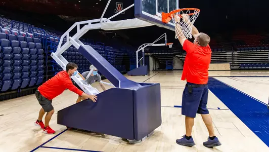 Jacob Gahart — David Oropeza — Mike Hairgrove — TUCSON, ARIZ. -- Facilities management team works on the McKale Center floor setup.Oct. 30, 2020. Photo by Mike Christy / Arizona Athletics