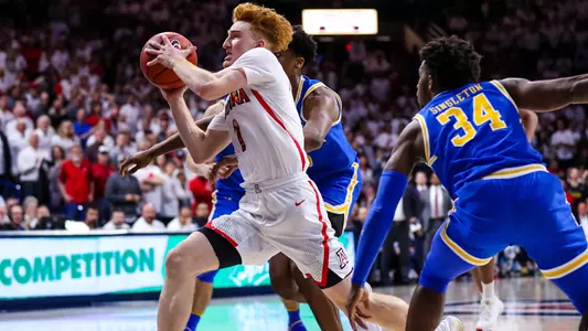 Nico Mannion drives the lane against UCLA