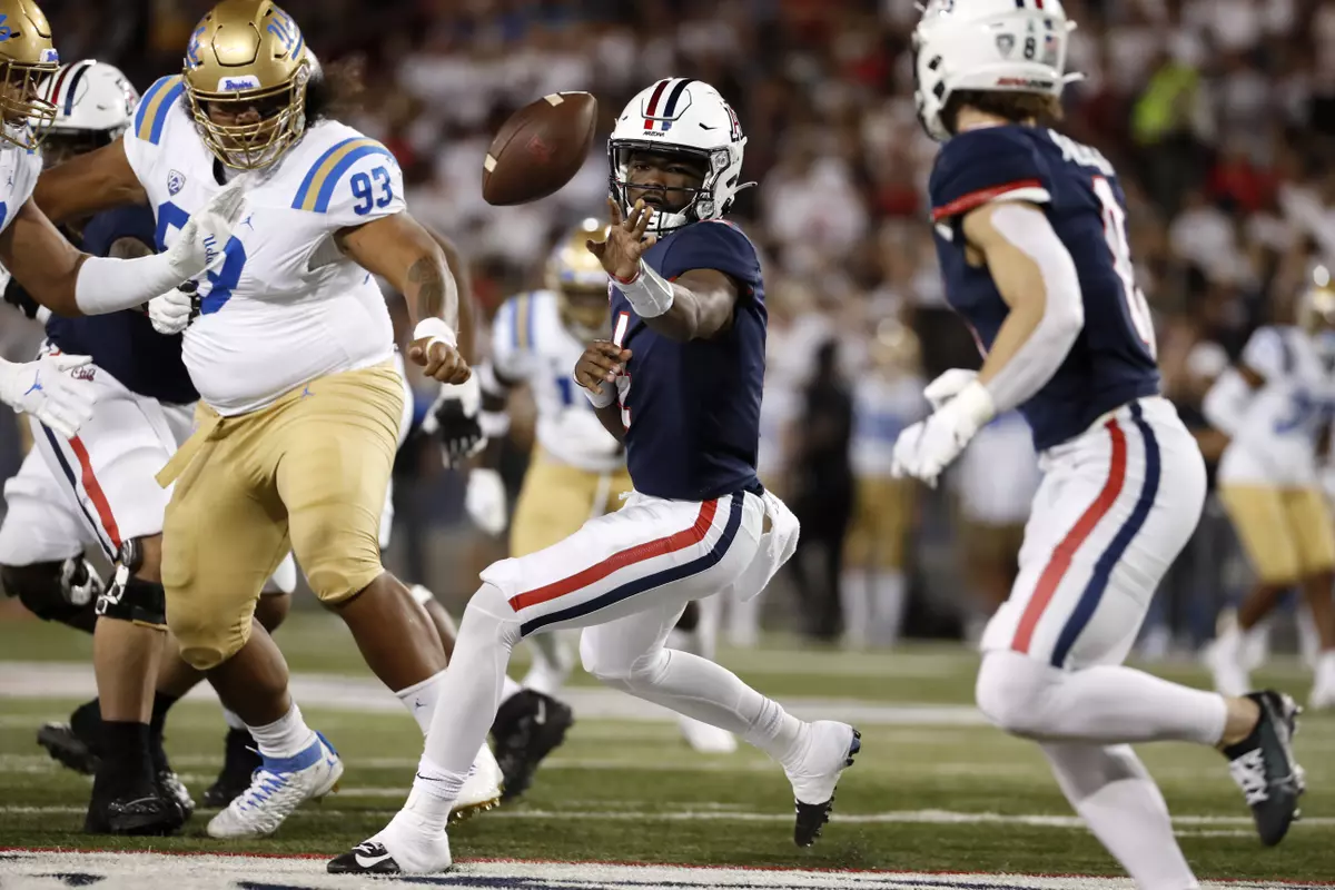 Arizona quarterback Jordan McCloud (4) tosses the ball during the first half of the team's NCAA college football game against UCLA on Saturday, Oct. 9, 2021, in Tucson, Ariz. (AP Photo/Chris Coduto)
