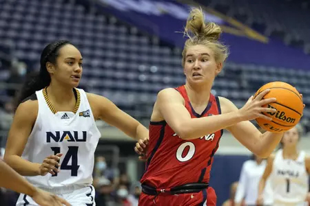 Arizona guard Anna Gret Asi drives on Northern Arizona guard Miki'ala Maio (14) during the first half of an NCAA college basketball game, Friday, Dec. 17, 2021, in Flagstaff, Ariz. (AP Photo/Rick Scuteri)